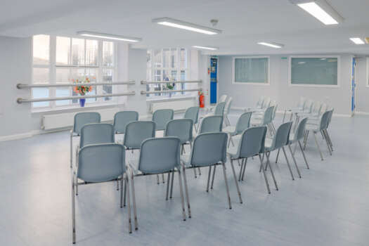 The Dining Room at All Souls Clubhouse, set up with chairs in rows.