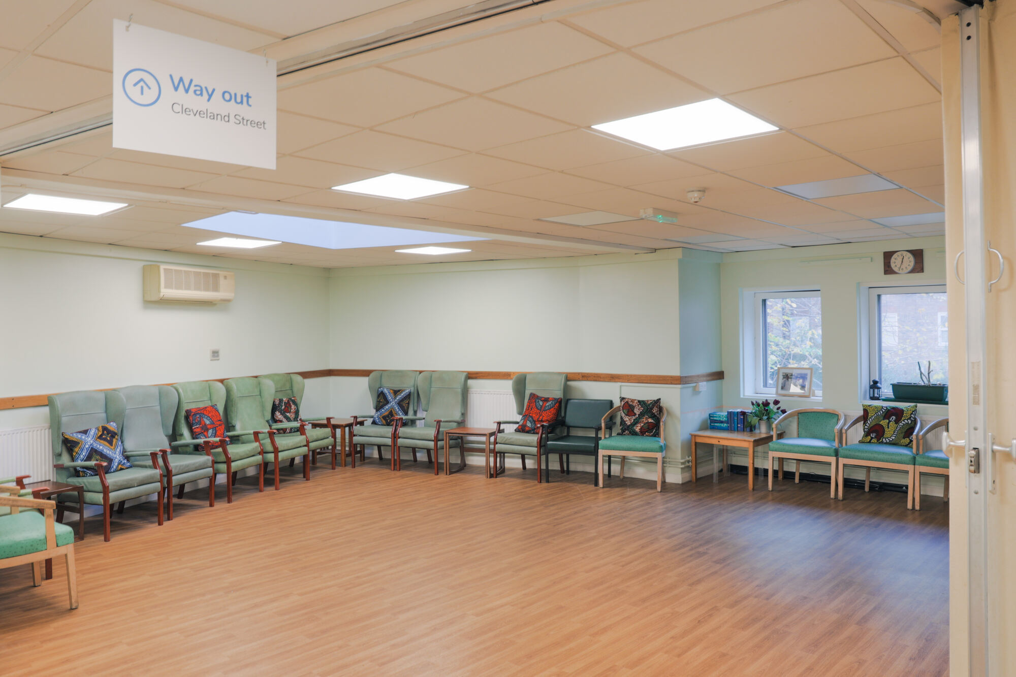 The Front Lounge at All Souls Clubhouse, set up with chairs around the edge of the room.