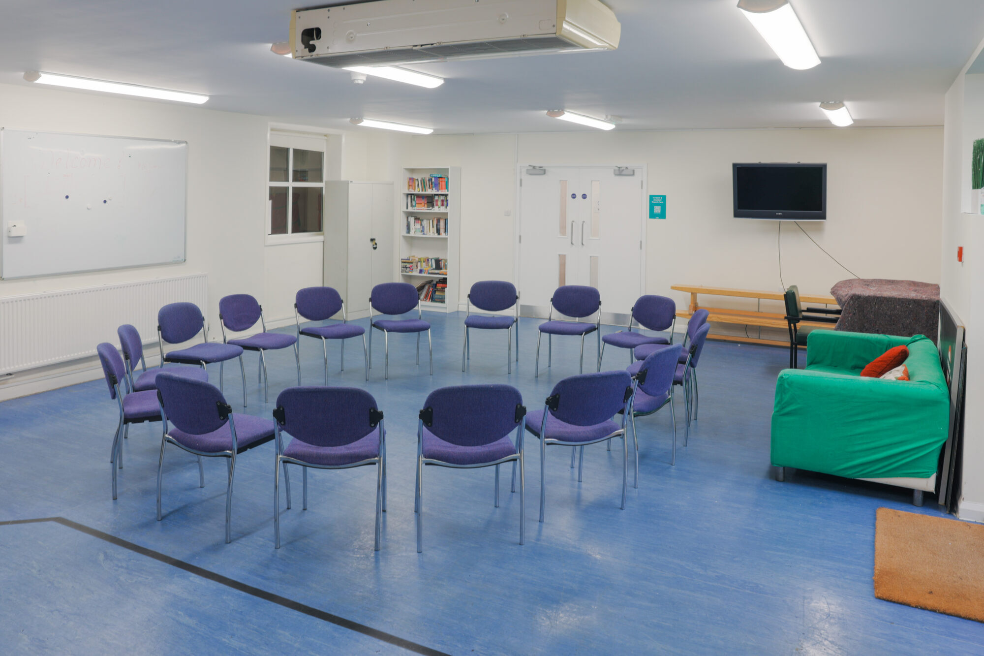 The Greenwell Room at All Souls Clubhouse, set up with chairs in a circle.