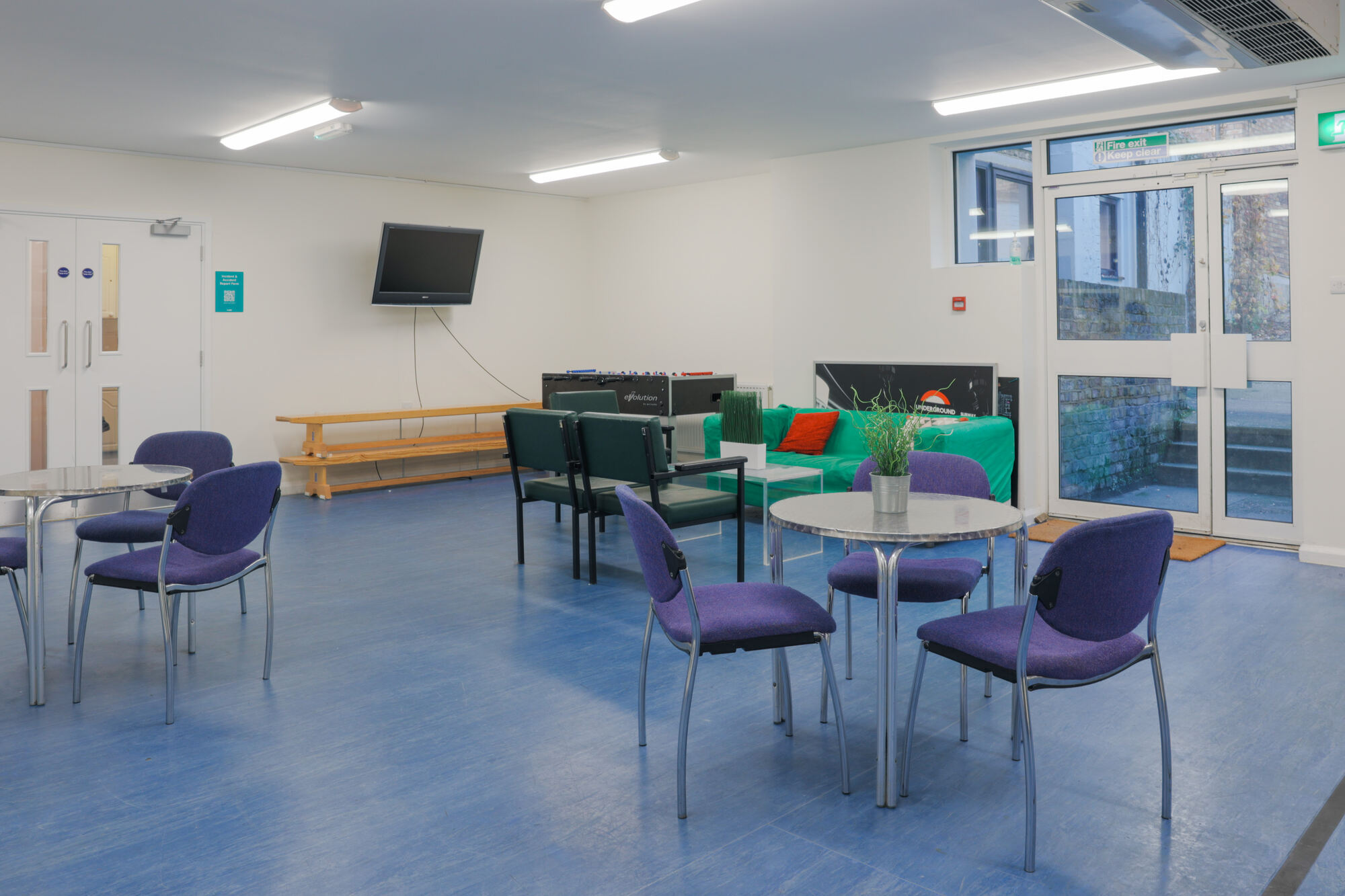 The Greenwell Room at All Souls Clubhouse, set up with tables and chairs.
