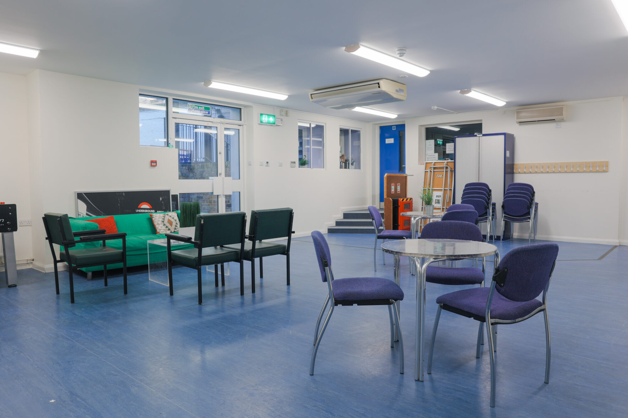 The Greenwell Room at All Souls Clubhouse, set up with tables and chairs.