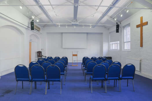 The Upper Room at All Souls Clubhouse, set up with chairs in rows.