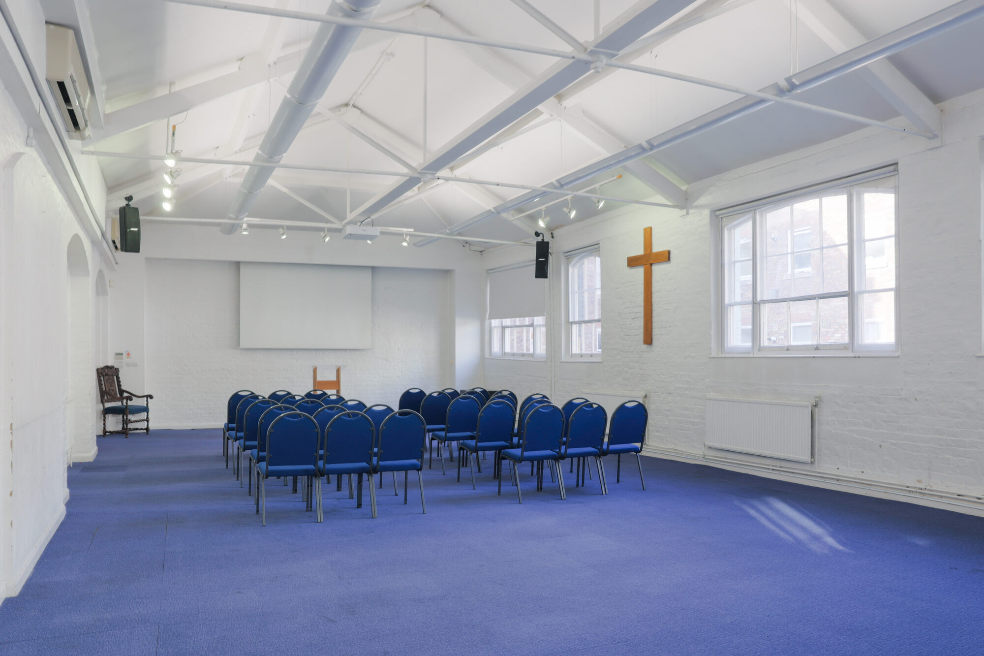 The Upper Room at All Souls Clubhouse, set up with chairs in rows.