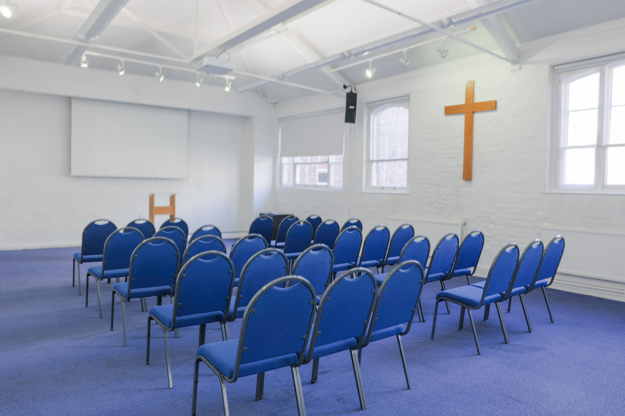 The Upper Room at All Souls Clubhouse, set up with chairs in rows.