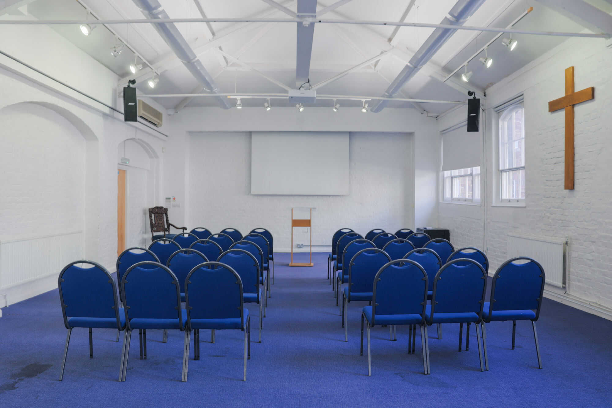 The Upper Room at All Souls Clubhouse, set up with chairs in rows.