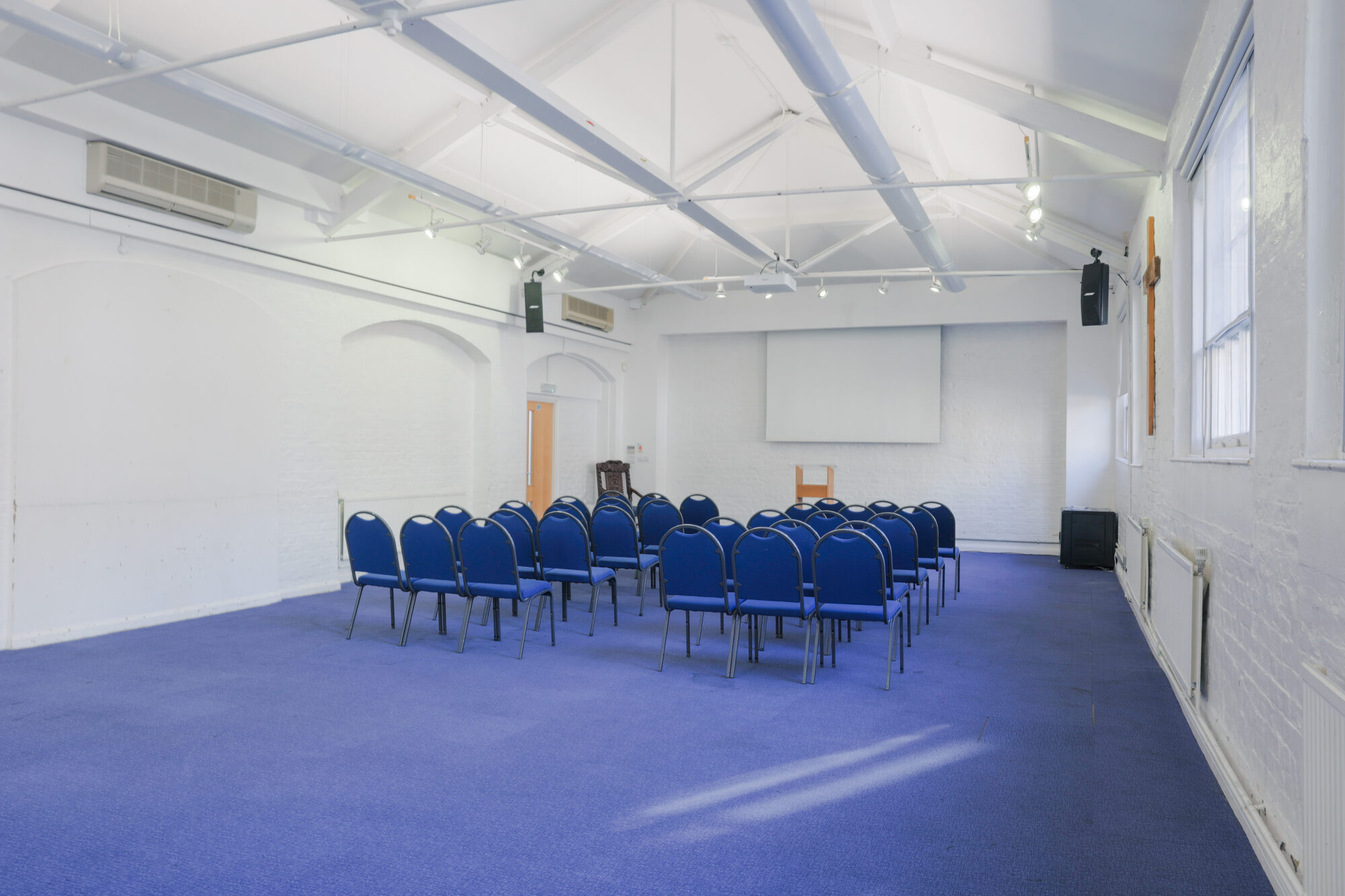 The Upper Room at All Souls Clubhouse, set up with chairs in rows.